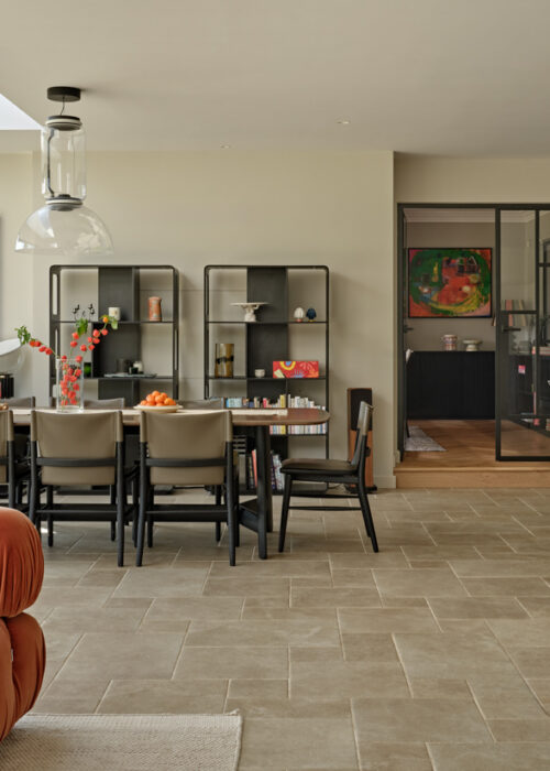 Modern country house  - traditional architecture meets contemporary interiors Modern country house kitchen with large sliding glass extension and stone effect floors