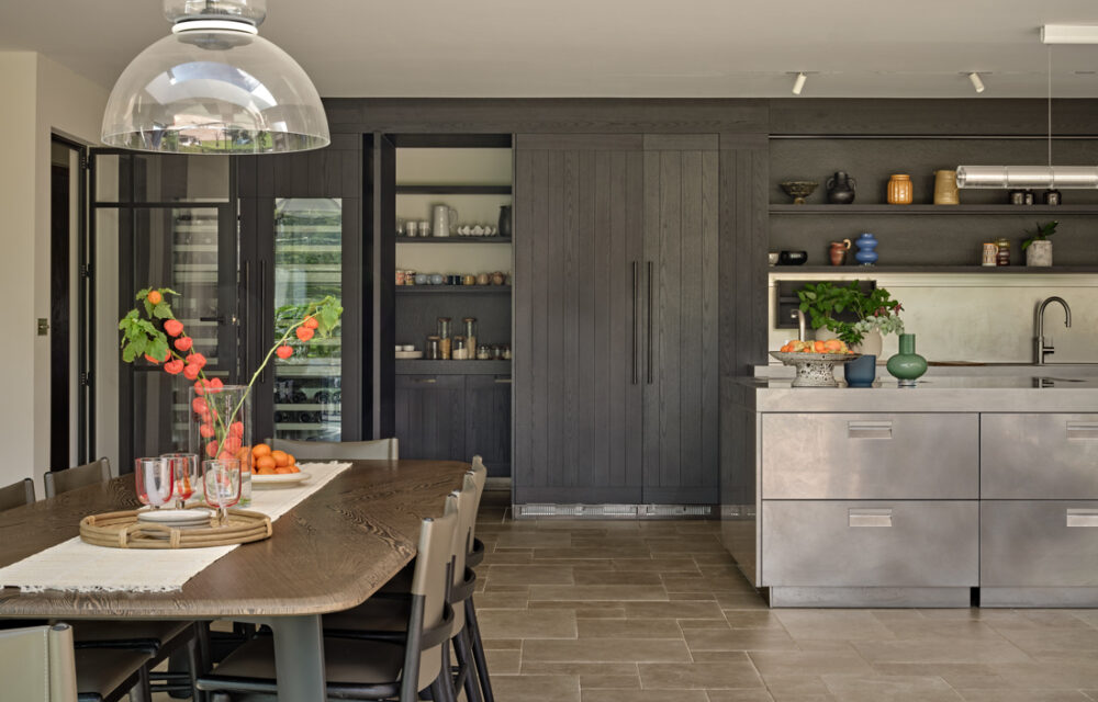 Modern country house kitchen with Arclinea kitchen and stone effect floors